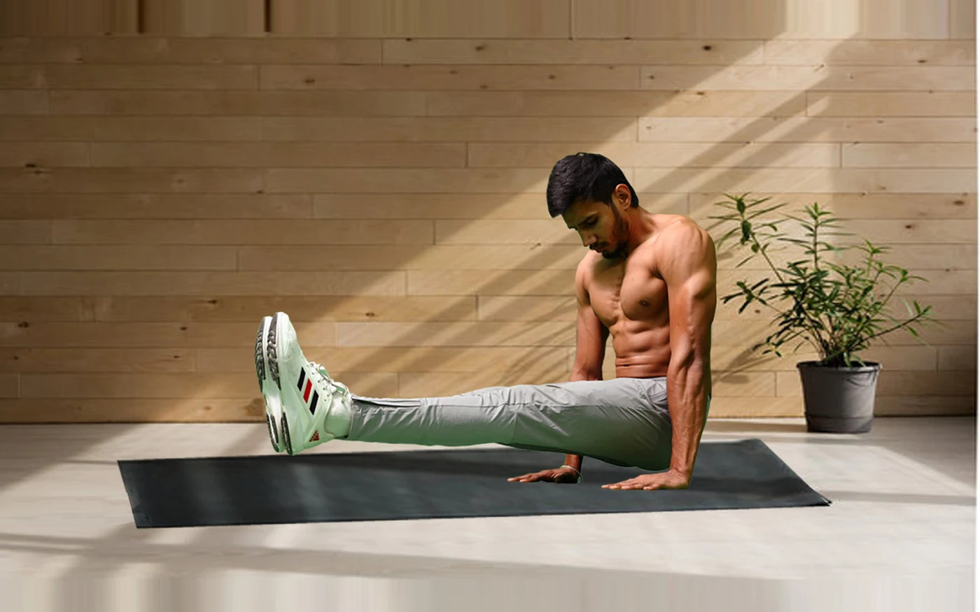 Maddy holding an L-sit in a bright studio — self-paced, hand-built programme